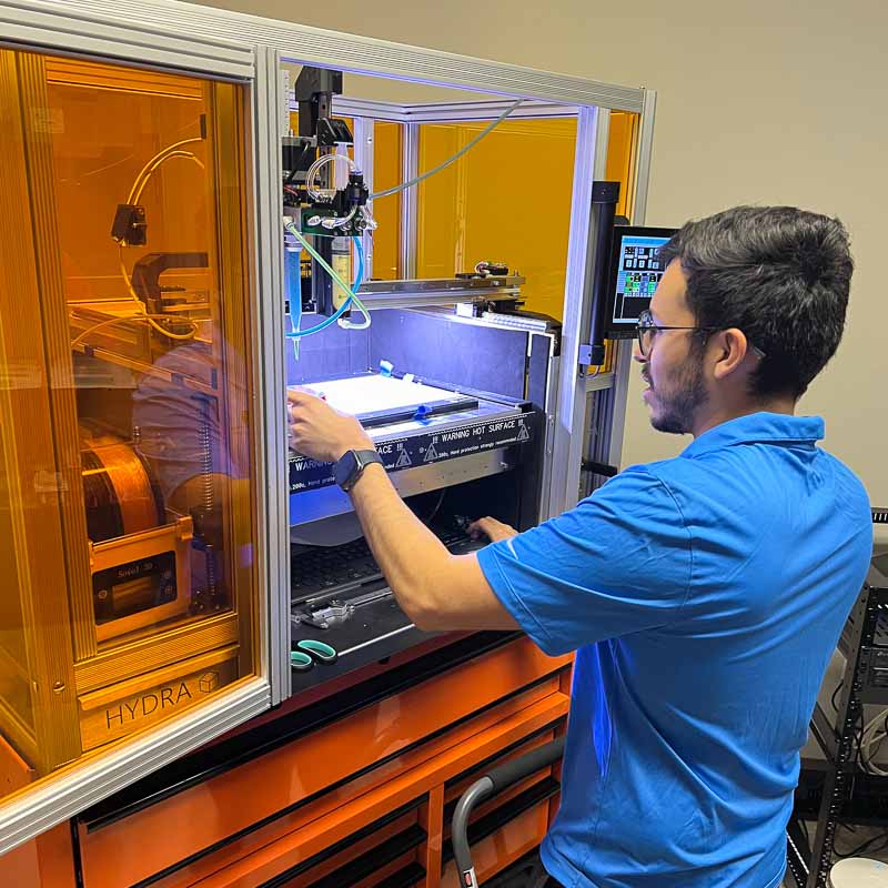 Kraetonics team member with 3D printer